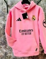 Pink Real Madrid hoodie featuring club logo, Adidas logo, and Emirates sponsorship.