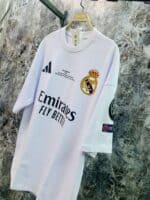 White Real Madrid away football jersey with club crest and sponsor logos.