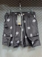 Black swim shorts with DG logo print for men.