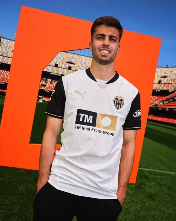 Valencia CF football jersey on male model at stadium.