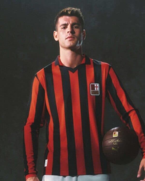 Milan football jersey with red and black vertical stripes, featuring club crest, worn by a young mal.