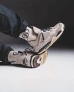Air Jordan 4 Fossil Stone sneakers with beige and black accents, stylish and comfortable.