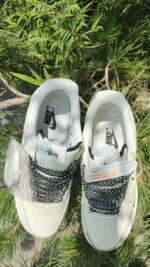 Air Force Low 1 07 White Black sneakers with black and white patterned laces.