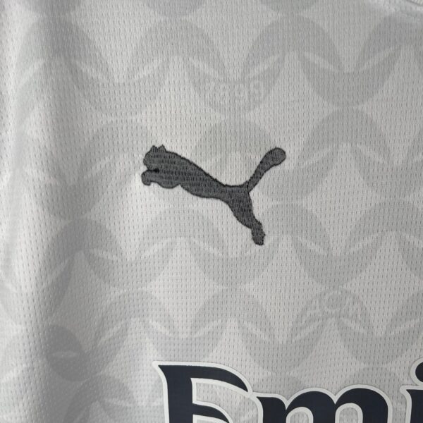 White Puma football jersey with black logo, lightweight sportswear for athletes.