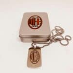 AC Milan logo pendant with chain on a jewelry box.