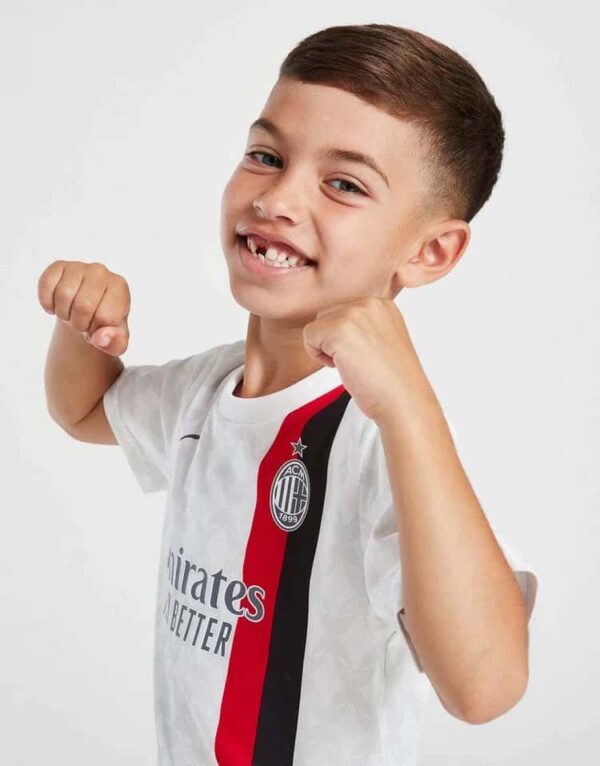 Kids Milan away football kit 2023/24 with authentic design and team logo. Perfect for young fans sup.