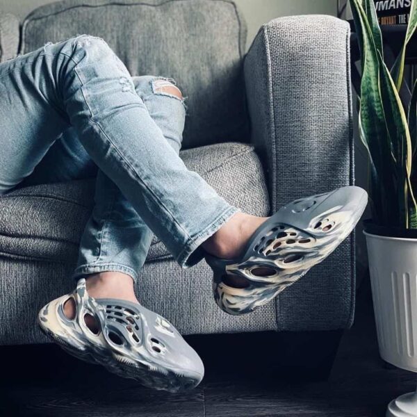 Yeezy Foam Runner MXT Moon Grey on a person's feet, casual indoor setting.