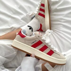 Adidas Campus 00s sneakers in white and red with iconic stripes and comfortable sole.
