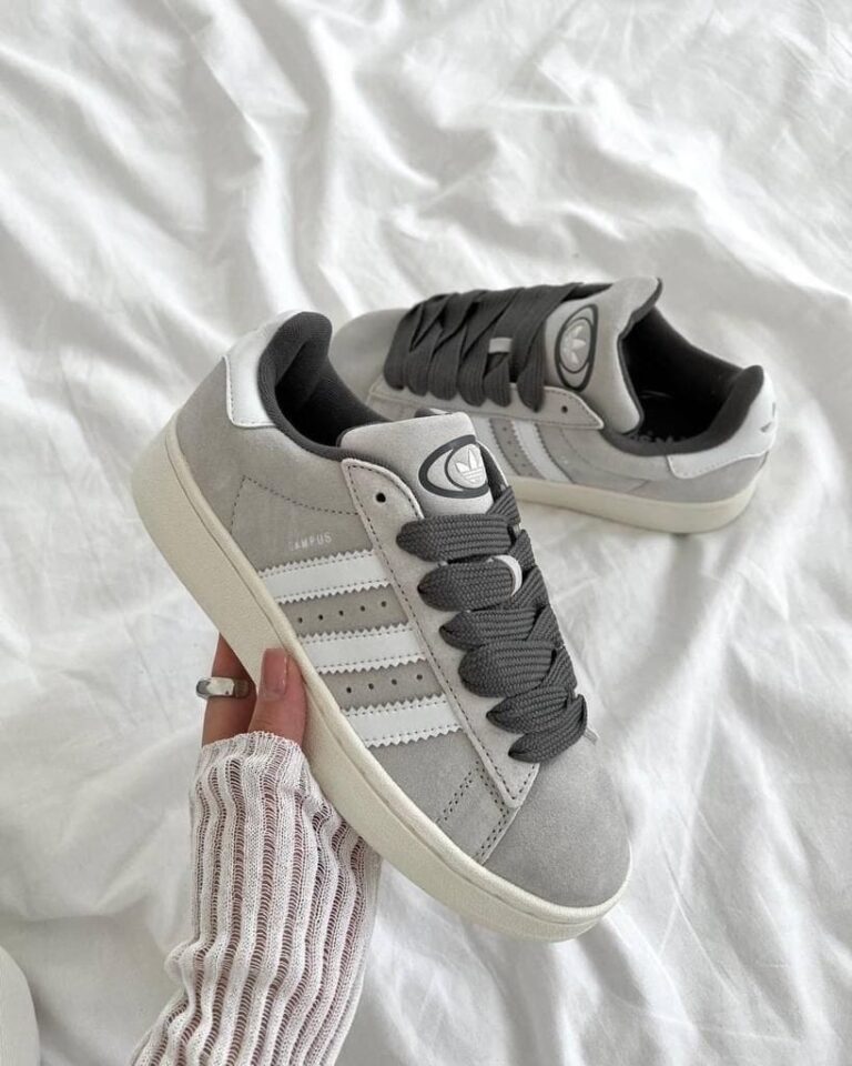Grey adidas Campus 00s sneakers with white stripes and black laces.