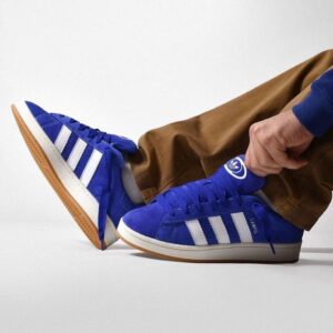 Blue adidas Campus sneakers with white stripes and gum sole.