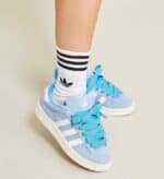 Sky blue adidas Campus 00s sneakers with white stripes and matching laces.
