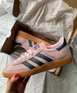 Authentic Adidas Handball Spezial sneakers in pink with black stripes and gum sole.