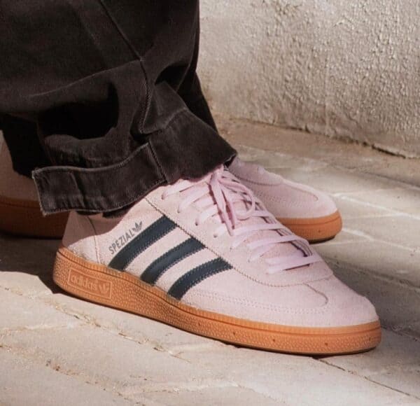 Adidas Handball Spezial sneakers in clear pink with black stripes and gum sole.