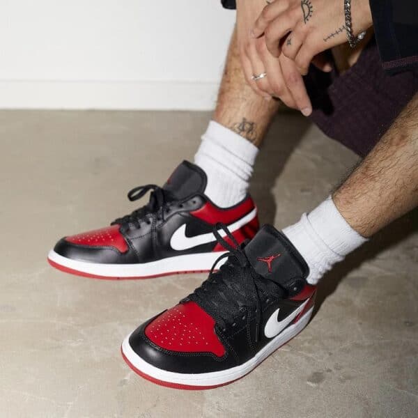 Air Jordan 1 "Alternate Bred Toe" black, red, and white sneakers with iconic design.