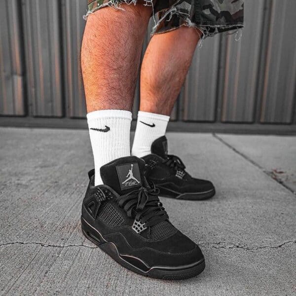 Air Jordan 4 Black basketball shoes with sleek design and durable construction.