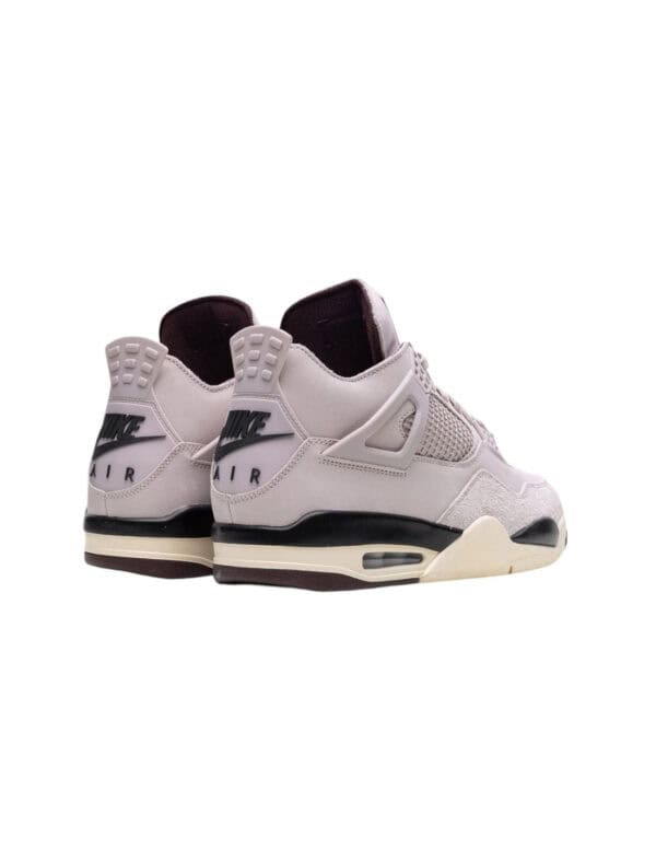 Air Jordan 4 Fossil Stone sneakers with white and black accents, iconic design, and premium material.