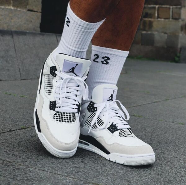 Air Jordan 4 Military Black sneakers with white and black accents, stylish and comfortable for sport.