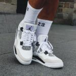 Air Jordan 4 Military Black sneakers with white and black accents.