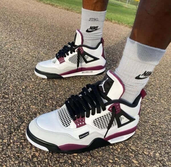 White and maroon Air Jordan 4 PSG basketball shoes with black accents.