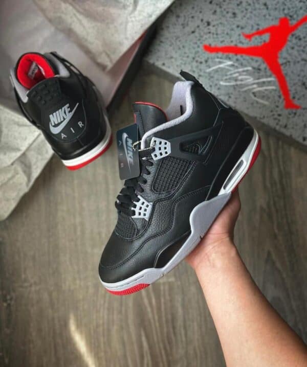 Air Jordan 4 Retro "Bred Reimagined" sneakers with black, red, and white design, iconic style, and p.