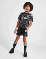 Bright black kids football kit with Ajax logo and Ziggo sponsor.