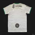 Al-Ahli Saudi away football jersey with green accents and sponsor logos, perfect for fans supporting.
