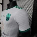 Authentic Al-Ahli Saudi away soccer jersey with team crest and green accents.