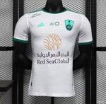 Al-Ahli Saudi away soccer jersey with team crest and sponsor logo. Authentic football kit for fans a.