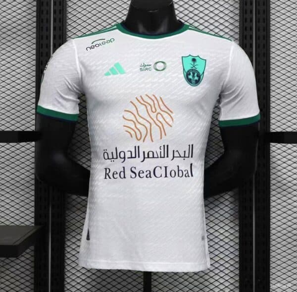 Al-Ahli Saudi away soccer jersey with team crest and sponsor logo. Authentic football kit for fans a.