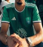 Authentic green Al-Ahli Saudi soccer jersey for fans, featuring team crest and stylish design.