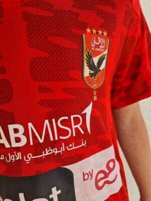 Al Ahly Kids Home Jersey 2022/23 with club crest and vibrant red design. Perfect for young fans supp.