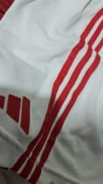 Kids' Al Ahly home football jersey for 2023/24 season, white with red stripes.