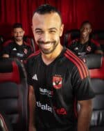 Al Ahly SC away football jersey 2023-2024 with team logo and red and black design.