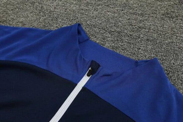 Blue Al Nassr football tracksuit top with white zipper for 2023/24 season.