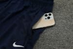 High-quality Nike blue tracksuit with a smartphone in the pocket, ideal for football training and sp.