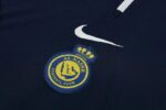 Al Nassr football club logo on blue tracksuit, official sportswear for 2023/24 season.