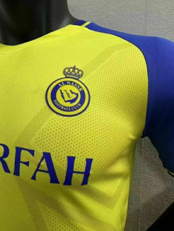 Al Nassr home player jersey with Ronaldo 7 logo and club crest.
