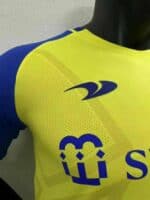 AL Nassr home player version jersey with Ronaldo 7 logo and vibrant yellow and blue design.