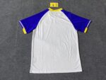 Training jersey with blue and yellow accents, featuring team logo and comfortable fit.