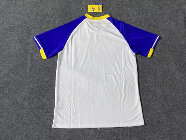 Training jersey with blue and yellow accents, featuring team logo and comfortable fit.
