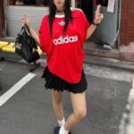 Adidas Adicolor red T-shirt with white logo, casual streetwear style.