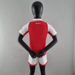 Official Arsenal Kids Home Football Kit 2022/23 with red and white design.
