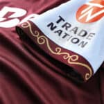 Aston Villa 2025/26 home football jersey with Trade Nation logo, featuring maroon and sky blue color.
