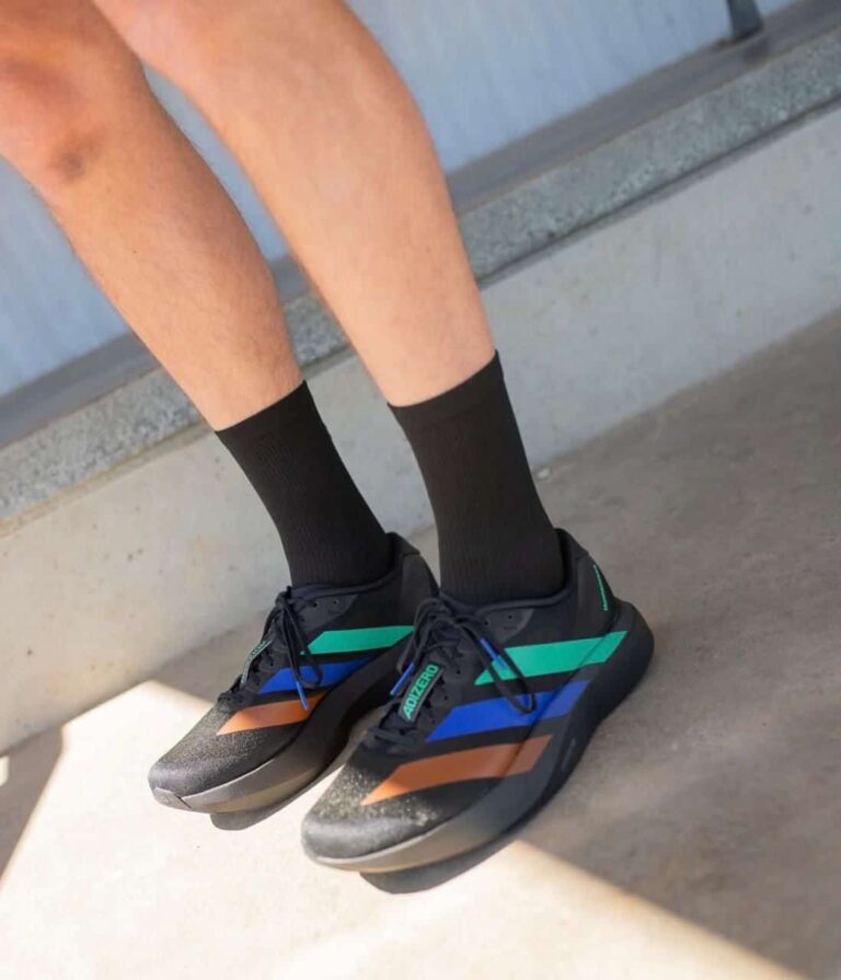 High-performance Adidas Adizero Evo SL Pharrell Humanrace sneakers in black, green, and blue. Perfec.