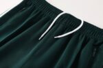 ملابس رياضية أنيقة من Adidas باللون الأخضر الداكن.