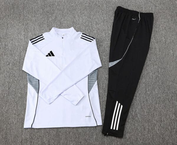 White Adidas sports tracksuit with black accents and logo.