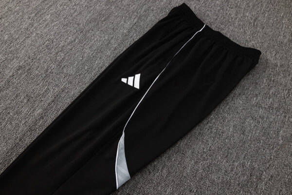 Adidas white tracksuit pants with black accents, ideal for sports and casual wear.