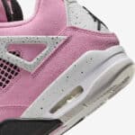 Air Jordan 4 Orchid pink and white athletic shoes with black speckled accents.