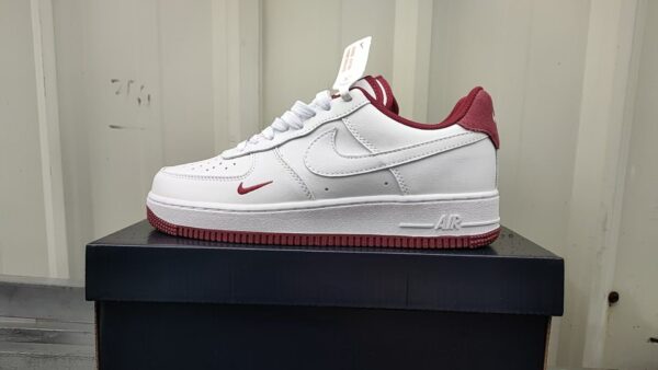 Nike Air Force Low 1 sneakers in white and red for men and women.