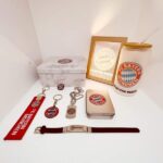 Authentic Bayern Munich fan gear including keychains, lanyard, notebook, and drink cup. Perfect for.
